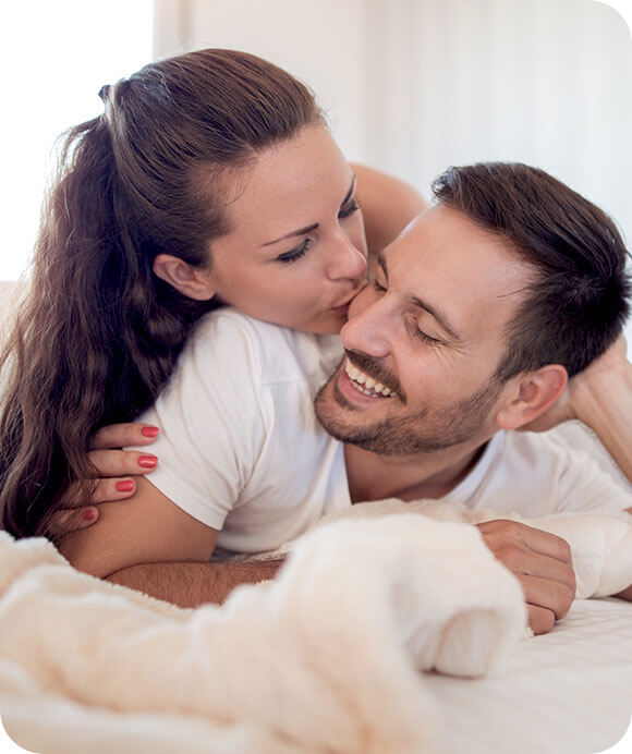Woman kissing smiling man